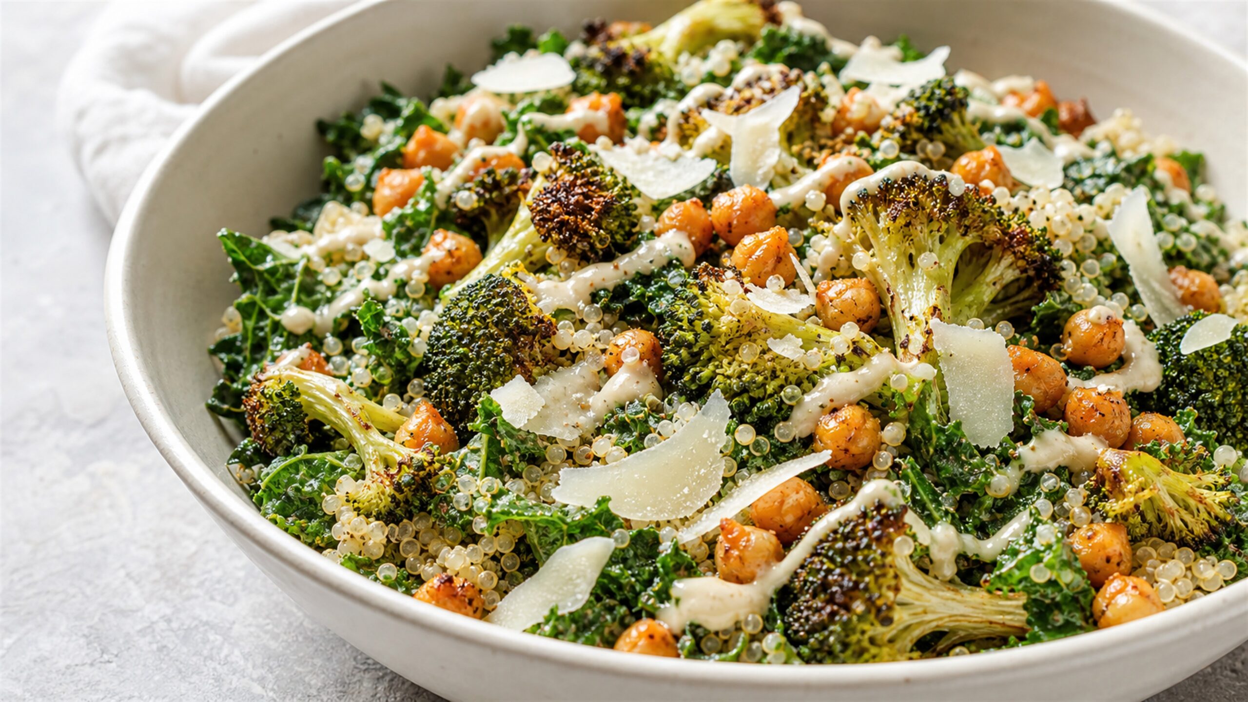 Kale chickpea quinoa salad with roasted broccoli, parmesan and tahini dressing